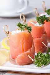 Banquet. Rolls of red fish with cream cheese close-up vertical