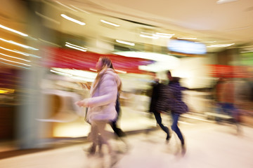 Young women walking past store in clothes shop