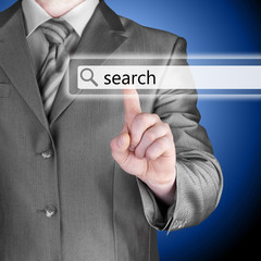 Businessman pushing virtual search bar
