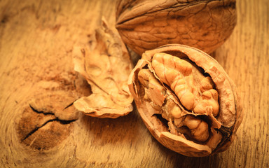 Whole walnuts on rustic old wooden table