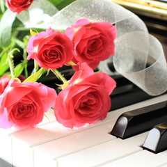 rose bouquet on piano keyboard