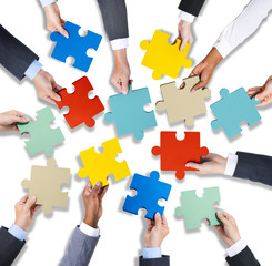 Group of Business Hands Holding Jigsaw Puzzles