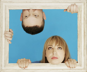 White Couple Behind Wooden Frame
