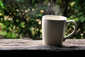 White coffee cup on a wooden table.
