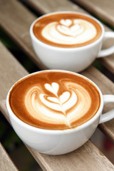 cup of latte art coffee on table