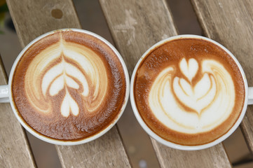 cup of latte art coffee on table