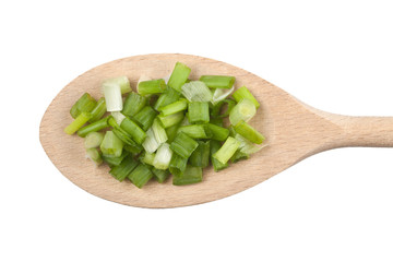 Chopped spring onion on wooden spoon isolated on white