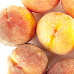 Ripe peaches over white