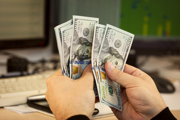 Man hand hold money on office background