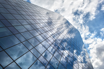 Skyscraper with reflection of blue sky and clouds