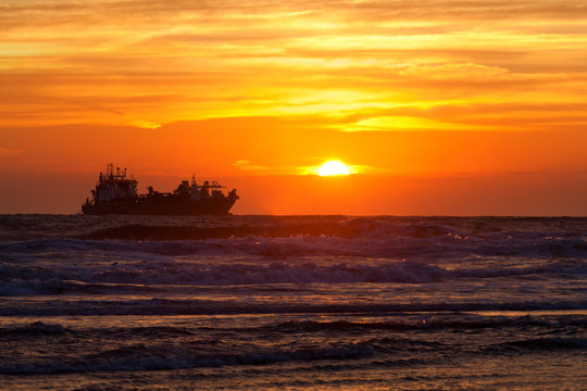 ship silhouette on North sea at sunset