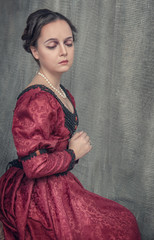 Sad beautiful woman in medieval dress
