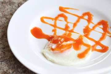 Fried egg with chili sauce.