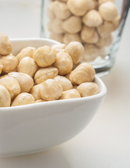 Closeup view of hazelnuts on white background