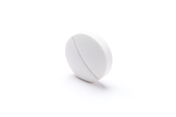 White circular tablet, isolated. Healthcare concept.