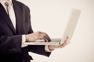 Asian business man using laptop computer isolated on white backg