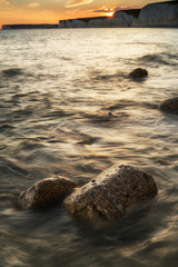 Landscape image of sunset over Birling Gap in England