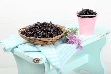 Fototapeta na wymiar Fresh berries in baskets on white wall background