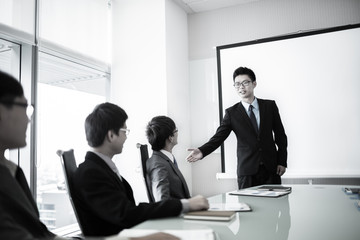 businessman giving a presentation to his colleagues