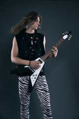 Male hard rock electric guitar musician with long hair. Studio s