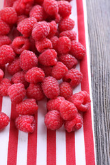 Ripe sweet raspberries on table close-up