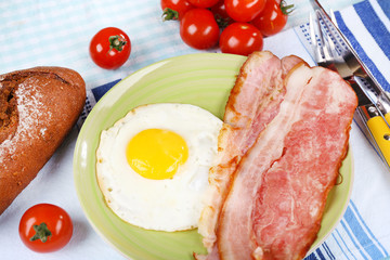 Scrambled eggs with bacon and vegetables served