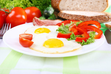 Scrambled eggs with bacon and vegetables served