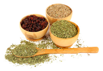 Round wooden bowl and spoon full of seasoning