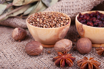 Round wooden bowl of seasoning and bay leaves