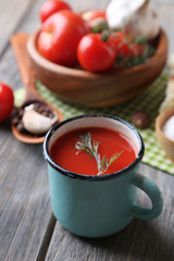 Homemade tomato juice in color mug, bread sticks, spices and