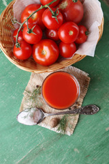 Homemade tomato juice in glass, spices and fresh tomatoes