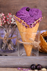 Tasty ice cream with berries in waffle cone