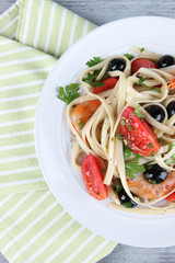 Fresh prawns with spaghetti, olives, tomatoes and parsley in a
