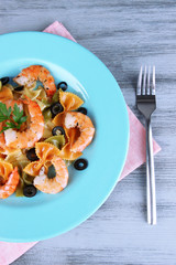 Fresh prawns with coloured macaroni, olives and parsley in a