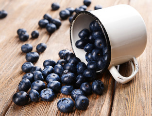 Delicious blueberries in cup on table close-up