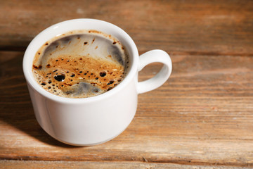 Cup of coffee on wooden background