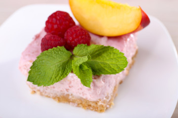 Cake with fruits and berries on plate on wooden background