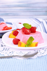 Cakes with fruit and berries on plate on lace napkin