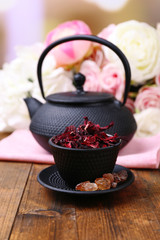 Black teapot, bowl and hibiscus tea