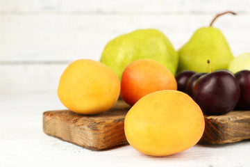 Ripe fruits on table on wooden background