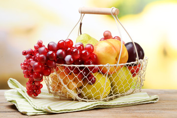 Assortment of juicy fruits in wicker basket