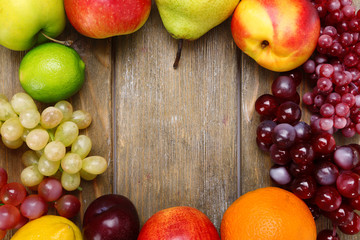 Assortment of juicy fruits on wooden background