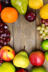 Assortment of juicy fruits on wooden background