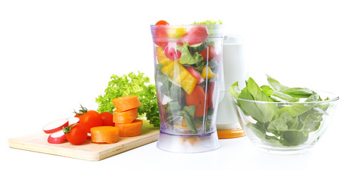Blender with fresh vegetables isolated on white