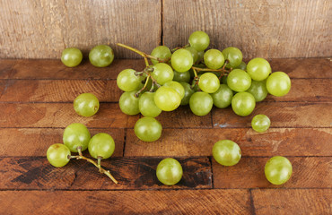 Green grape on wooden table on wooden background
