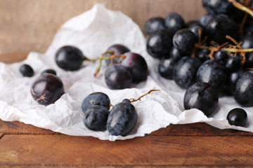Purple grape on wooden background