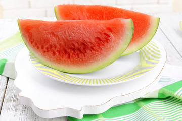 Juicy watermelon on table on brick wall background