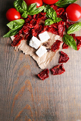 Sun dried and fresh tomatoes, basil leaves and feta cheese