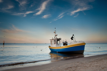 Naklejka na ściany i meble fishing boat on the beach, baltic sea