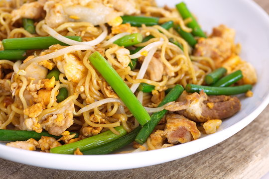 Chinese stired fried noodles with leek vegetable and pork